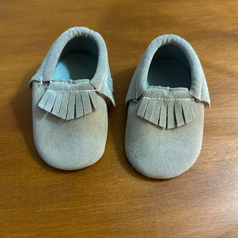 Gray infant 0-6 mo moccasins. No brand. Never worn; few marks bottom left shoe